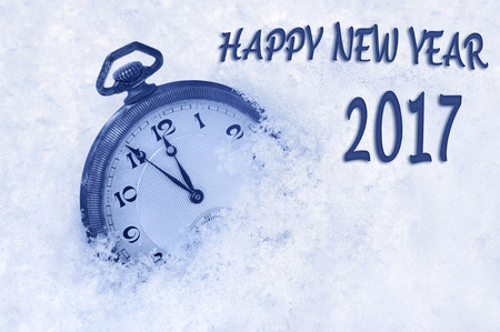 58323103 - new year 2017 greeting in english language, pocket watch in snow, happy new year 2017 text